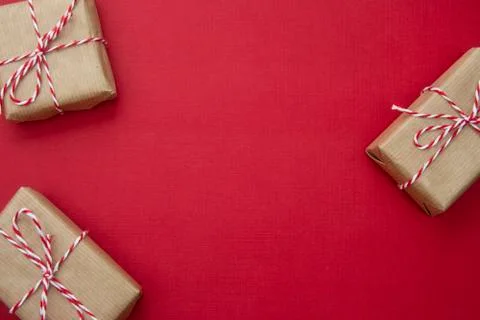 Craft gift boxes over red background. Christmas mockup with copy space. winte Stock-Fotos