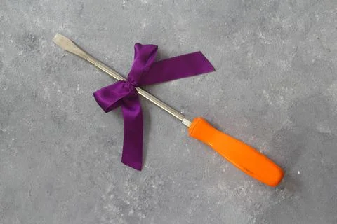 Craft gift with old tool on stone background. Fathers day concept. Stock Photos