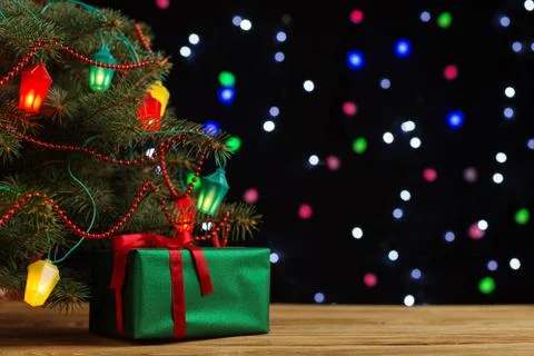 Craft gifts under the tree, on the table, against the background of blurry li Stock Photos