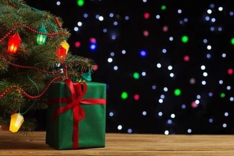 Craft gifts under the tree, on the table, against the background of blurry li Stock Photos