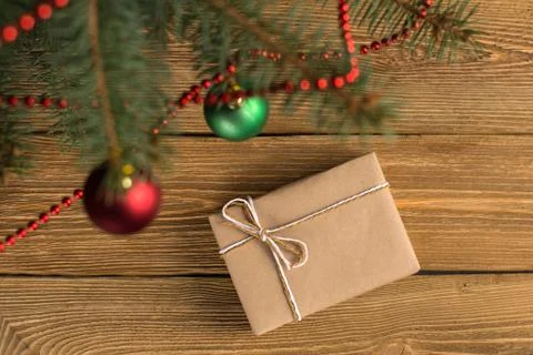 Craft gifts under the tree, on the table, against the wood background. The co Stock Photos