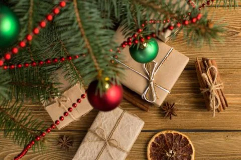 Craft gifts under the tree, on the table, against the wood background. The co Stock Photos