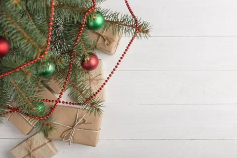 Craft gifts under the tree, on the table, against the white background. The c Stock Photos