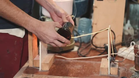 Craft man cutting the upper part of beer bottle with tool Stock Footage 145671065