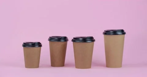 Craft paper coffee cups of different sizes stop motion animation 4k on pink  Stock Footage 231676893