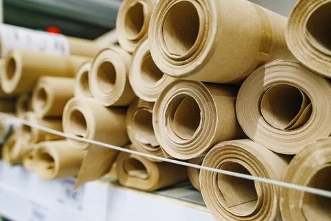 Craft paper rolls stack in warehouse selective focus Stock Photos