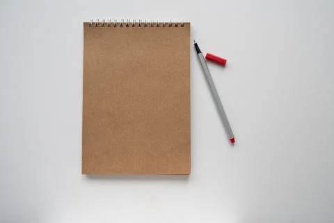Craft papper notebook and red pencil on white background, isolated. taking no Stock Photos