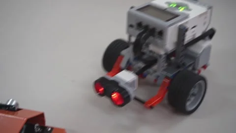 Craft for robotics class. Robot car made from LEGO construction kits and motors Stock Footage 258903064