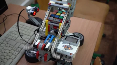 Craft for robotics class. A robot made from a LEGO set and motor solves a Rubik Stock Footage 265011970