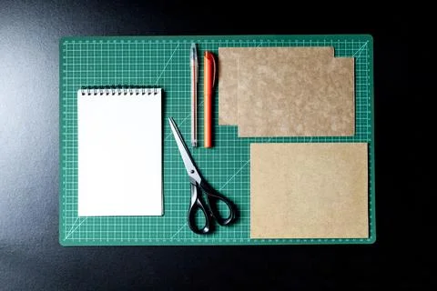 Craft table with clipboard, note sticker pen, pencil, paper scissors and card Stock Photos