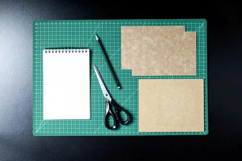 Craft table with clipboard, note sticker pen, pencil, paper scissors and card Stock Photos