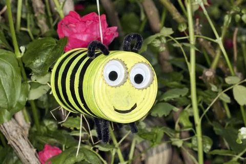 Craft work with a tin can to make a funny bee allotment garden Berlin Germany Fotos de archivo