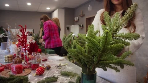 In craft workshop, florists are busy preparing for upcoming Christmas season by Stock Footage 316071207