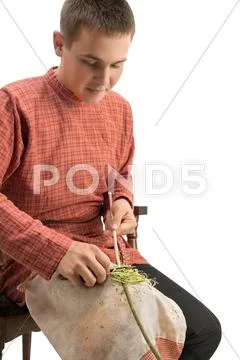 Craft. Young boy barks a twig, isolated on white Stock Photos