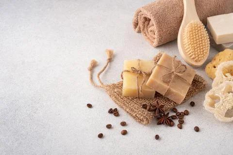 Crafted bars of soap with roasted coffee beans and bathroom items. Spa and se Stock Photos