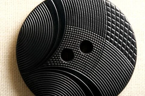 Crafted black button showcases intricate patterns and designs Stock Photos