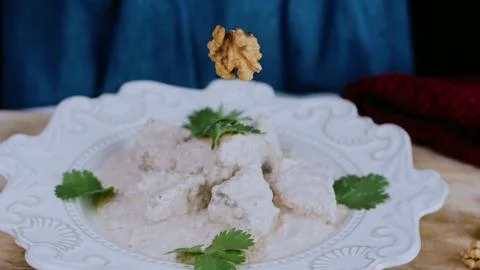Crafted culinary presentation: coating cooked duck with satsivi 스톡 사진