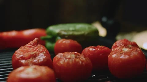 Crafted culinary view of tomatoes and peppers heating on ridged cast iron Stock Footage 342152680