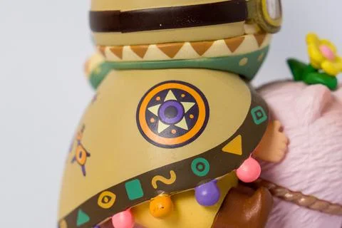 Crafted figure with tribal-inspired patterns and colorful beads Stock Photos