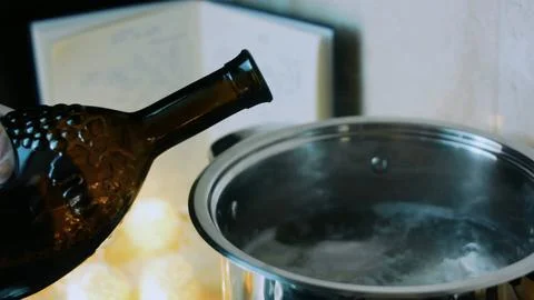Crafted ingredient study: placing chicken pieces in a pot Stock Photos
