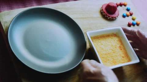 Crafted ingredient study of placing a gray plate over the flan mold Stock Footage 342154061