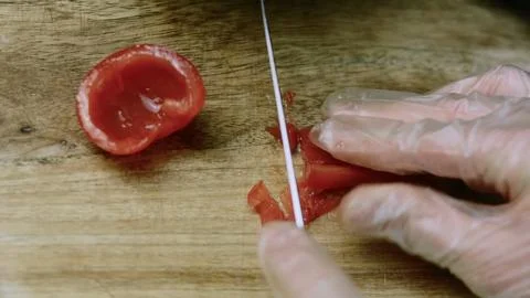 Crafted macro composition of knife cutting ripe tomatoes Stock Photos