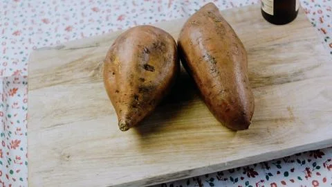 Crafted prepared ingredient view: slicing sweet potatoes into even pieces Stock Photos