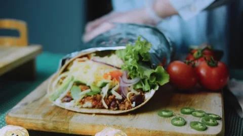 Crafted serving view: cutting a burrito to reveal its layers Stock Footage 342168146