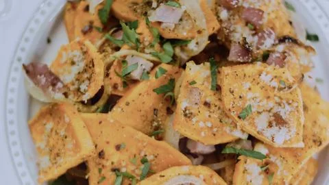 Crafted tabletop perspective: lifting a forkful of sweet potato and ham Fotos de archivo