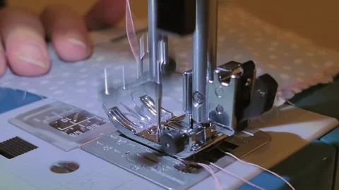 Crafting delicate patterns with precision in a cozy sewing space at night Stock Footage 327137233