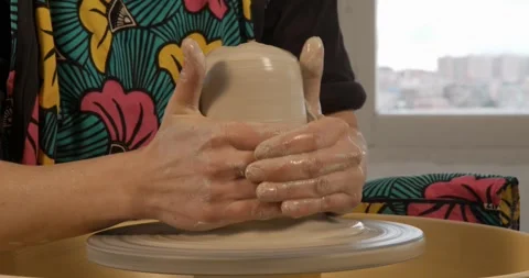 Crafting Elegance: Hands mould clay on a potter's wheel Stock Footage 329299911