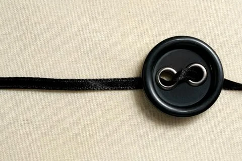 Crafting elegant designs with a black button and silk ribbon Foto stock