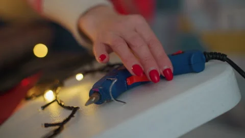 Crafting festive decorations. Creating holiday ornaments with glue and lights Stock Footage 335400030