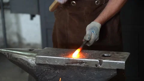 Crafting Hot Metal: An Artisan Blacksmith Shapes Iron with Precision and Skill Stock Footage 341316752