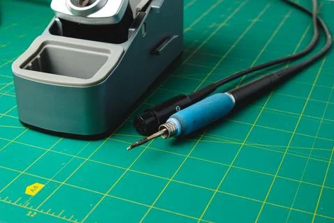Crafting an intricate design with precision tools on a vibrant workspace Photos