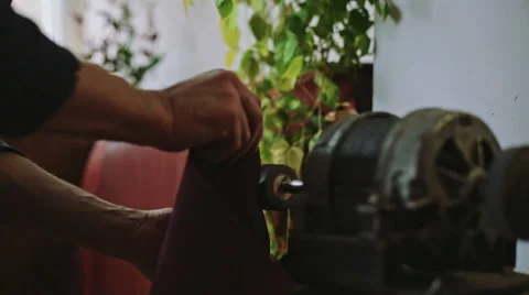 Crafting leather on a vintage machine. Tracking dolly shot Video stock 61033948