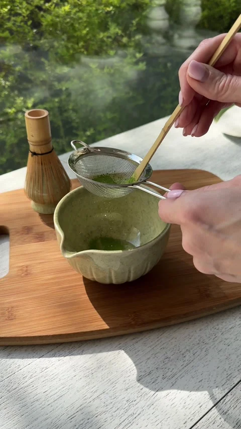 Crafting matcha tea: sifting, whisking, and preparing outdoor Stock Footage 320851411