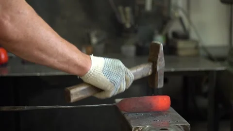Crafting Metal: A Skilled Blacksmith Shapes Steel with Precision and Strength Stock Footage 341316825