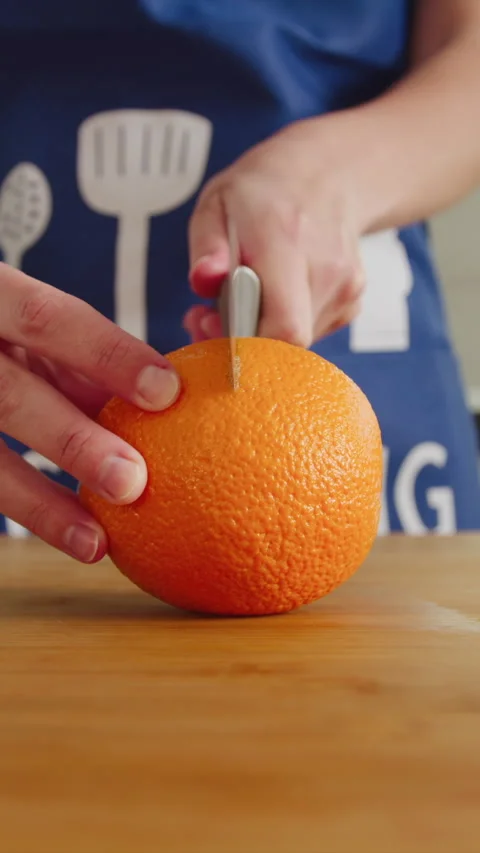 Crafting orange slices in a cozy kitchen for refreshing snacks Stock Footage 341763037