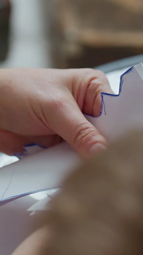 Crafting paper tree, Home crafter carefully creating festive paper decorations Stock Footage 326823868
