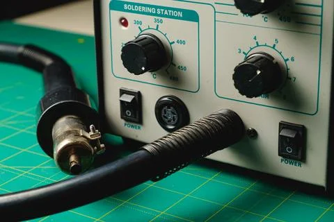 Crafting precision at a soldering station in a creative workspace Stock Photos