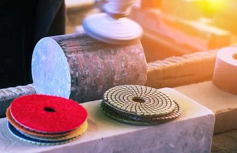 Crafting with precision in a workshop using various polishing pads at sunset Stock-Fotos