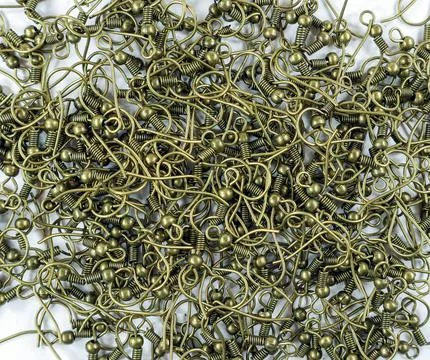 Crafting projects filled with bronze tone earring hooks ready for creative .. Stock Photos
