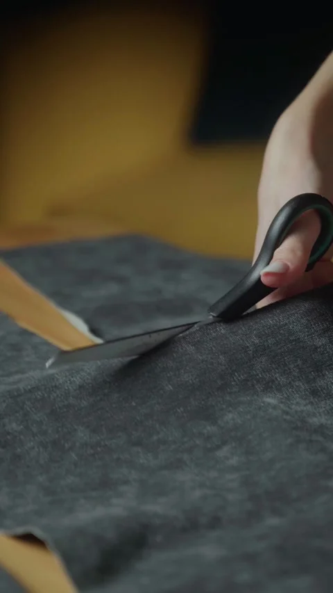 Crafting a stylish fabric project with precise cutting techniques in a cozy Stock Footage 303768726