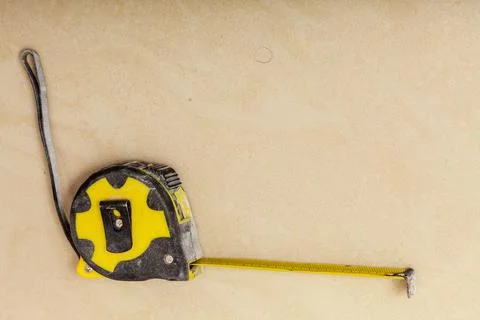 Crafting, tinkering objects. Black and yellow measuring tape Stock Photos