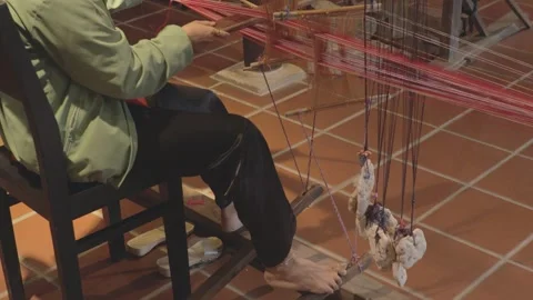 Crafting traditional textiles in a workshop using a hand loom Video stock 308836021