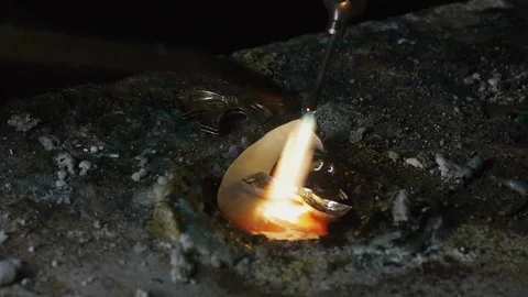 Craftman melts the silver with a flame Stock-Footage 82318138
