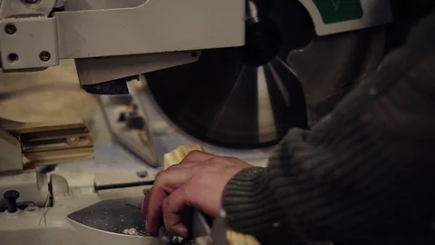 The craftman is working on electric saw machine. Sawing a large wooden bar. Man Stock Footage 121451998