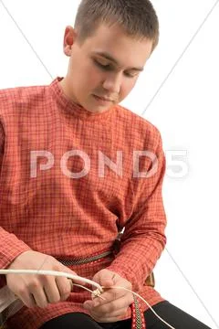 Crafts. Boy weaves basket, isolated on white Stock Photos