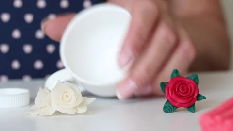 Crafts from polymer clay in different colors. A woman is preparing a cup for  Stock Footage 134565425